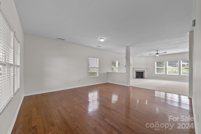 unfurnished living room with hardwood / wood-style floors and ceiling fan