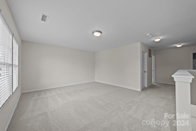 unfurnished room with light carpet