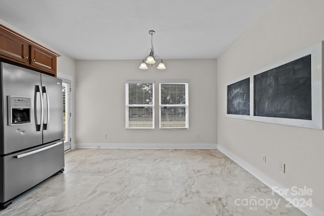 kitchen with decorative light fixtures, stainless steel fridge, and a notable chandelier