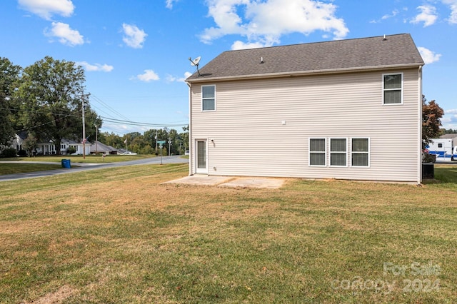 view of side of property with a yard and a patio