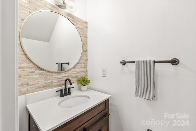 bathroom with vanity and tasteful backsplash