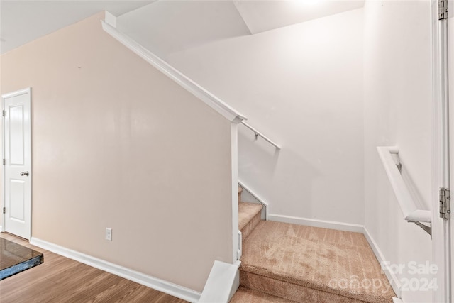 stairs featuring hardwood / wood-style floors