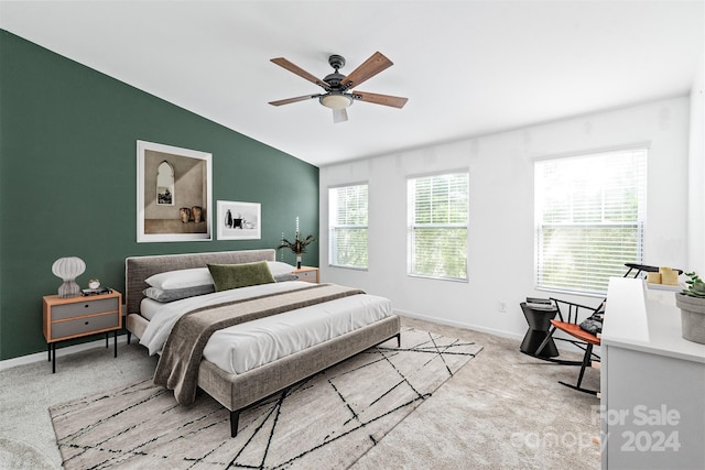 bedroom featuring light carpet, vaulted ceiling, and ceiling fan