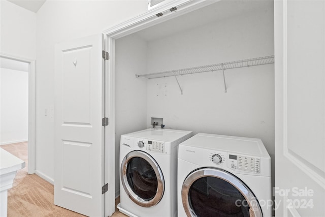 washroom featuring light carpet and washer and dryer