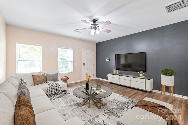 living room with hardwood / wood-style floors and ceiling fan