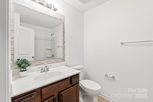 bathroom with vanity, toilet, and walk in shower