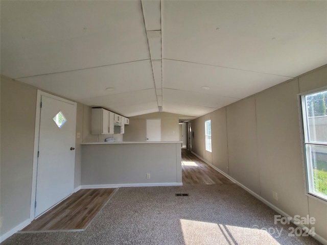 interior space with vaulted ceiling and hardwood / wood-style flooring