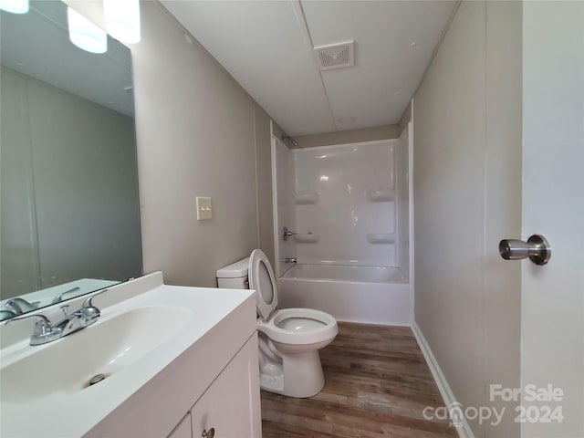 full bathroom with vanity, toilet, hardwood / wood-style floors, and bathing tub / shower combination