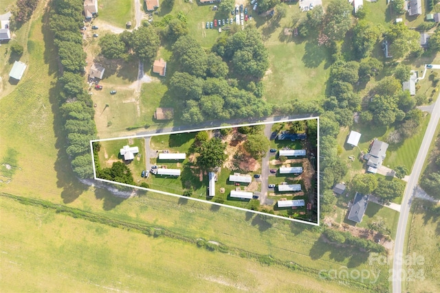 birds eye view of property with a rural view