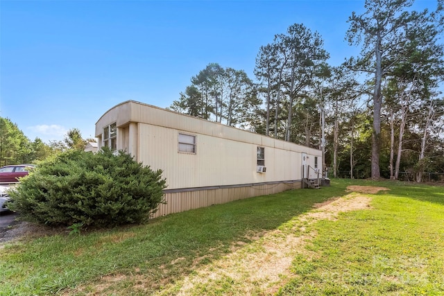 view of property exterior featuring cooling unit and a yard