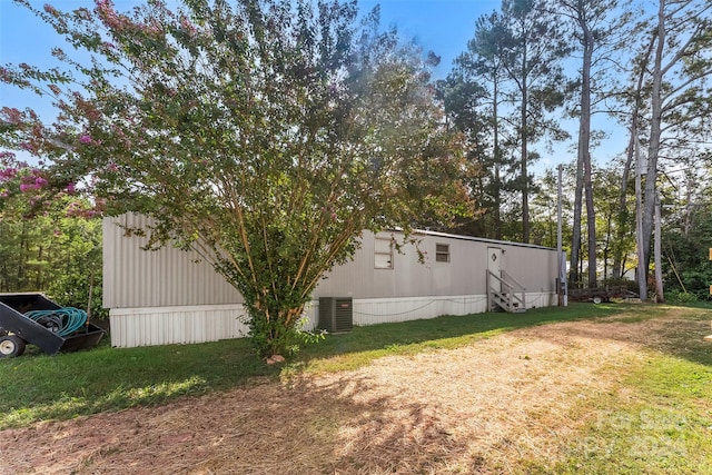 view of yard featuring an outbuilding and central air condition unit