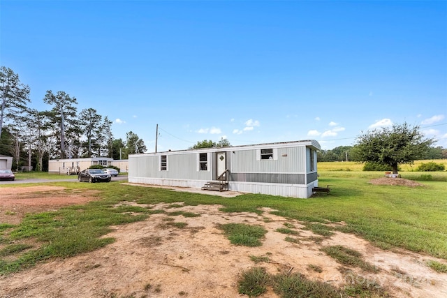 back of property with a lawn