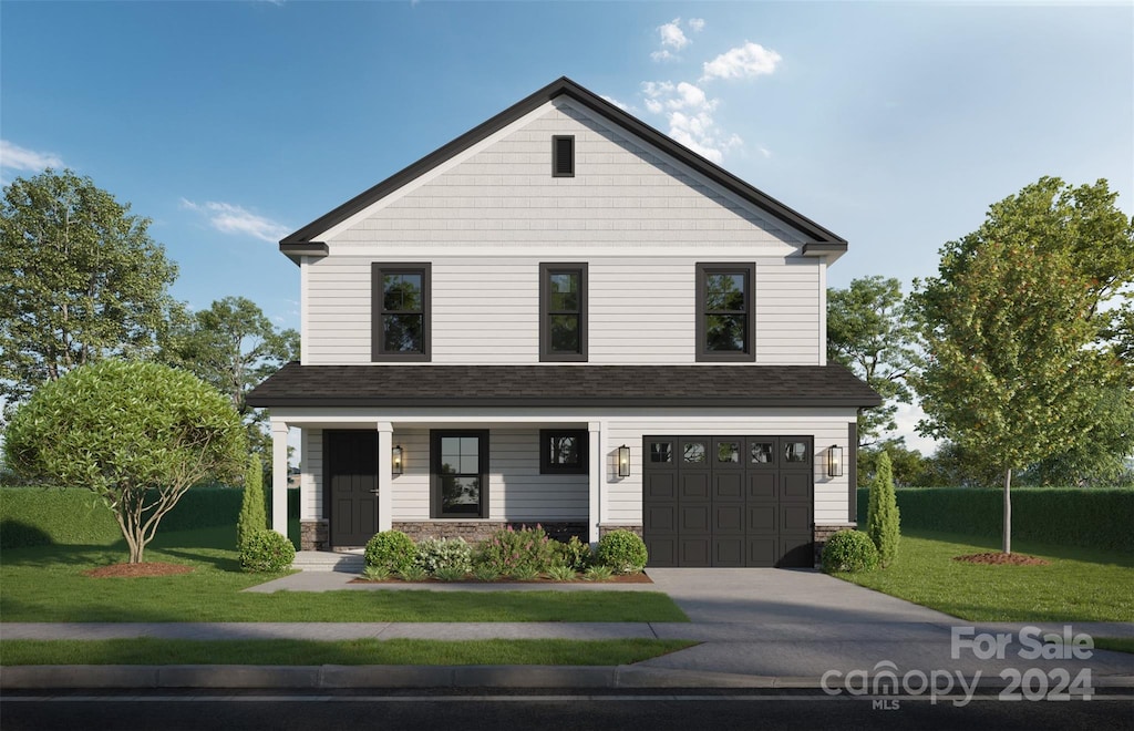 view of front of home with a garage and a front lawn