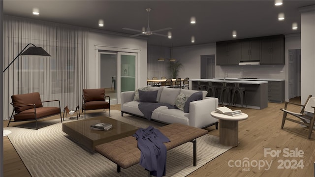 living room with light wood-type flooring, ceiling fan, and ornamental molding