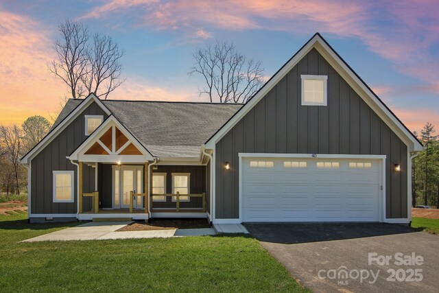 40 Haywood Park Dr, Hendersonville, NC 28791 - modern farmhouse featuring board and batten siding, a shingled roof, asphalt driveway, and a front lawn