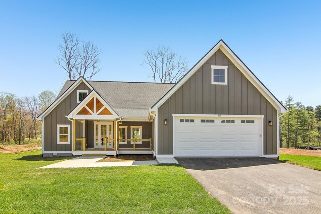 40 Haywood Park Dr, Hendersonville, NC 28791 - view of front of property with a front lawn, french doors, driveway, a garage, and a shingled roof
