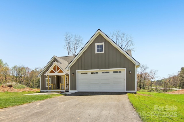 40 Haywood Park Dr, Hendersonville, NC 28791 - view of front facade featuring a front lawn, a garage, and board and batten siding