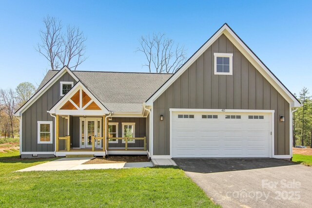 40 Haywood Park Dr, Hendersonville, NC 28791 - modern farmhouse with board and batten siding, roof with shingles, asphalt driveway, a front lawn, and an attached garage
