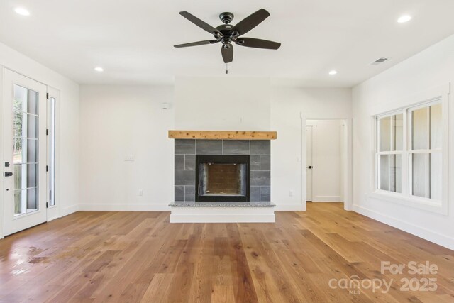 40 Haywood Park Dr, Hendersonville, NC 28791 - unfurnished living room featuring wood finished floors, recessed lighting, a tile fireplace, baseboards, and ceiling fan