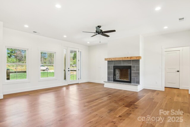 40 Haywood Park Dr, Hendersonville, NC 28791 - unfurnished living room with light wood-style floors, a tiled fireplace, a ceiling fan, recessed lighting, and baseboards