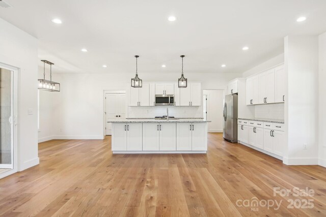 40 Haywood Park Dr, Hendersonville, NC 28791 - kitchen with stainless steel appliances, backsplash, white cabinetry, and recessed lighting