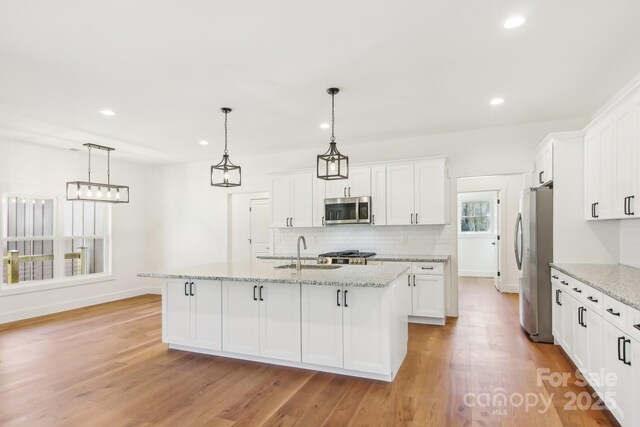 40 Haywood Park Dr, Hendersonville, NC 28791 - kitchen with stainless steel appliances, a sink, backsplash, white cabinets, and recessed lighting