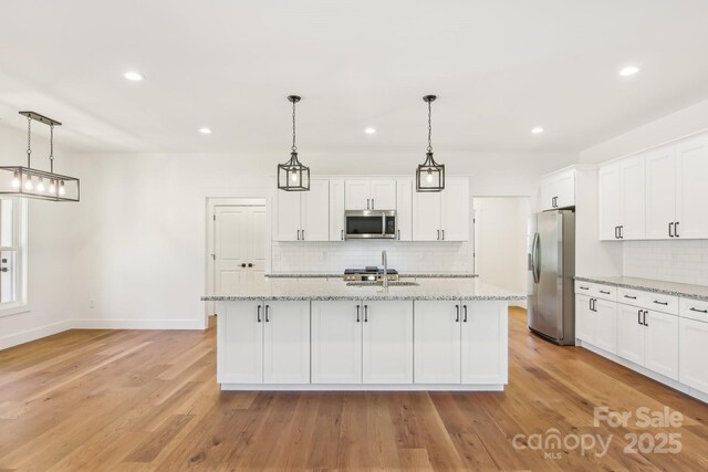40 Haywood Park Dr, Hendersonville, NC 28791 - kitchen with stainless steel appliances, a sink, decorative backsplash, white cabinetry, and recessed lighting