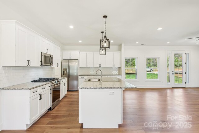 40 Haywood Park Dr, Hendersonville, NC 28791 - kitchen featuring appliances with stainless steel finishes, a sink, recessed lighting, a center island with sink, and white cabinetry