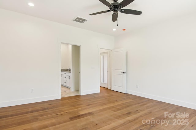 40 Haywood Park Dr, Hendersonville, NC 28791 - unfurnished bedroom featuring baseboards, recessed lighting, light wood-style flooring, and connected bathroom