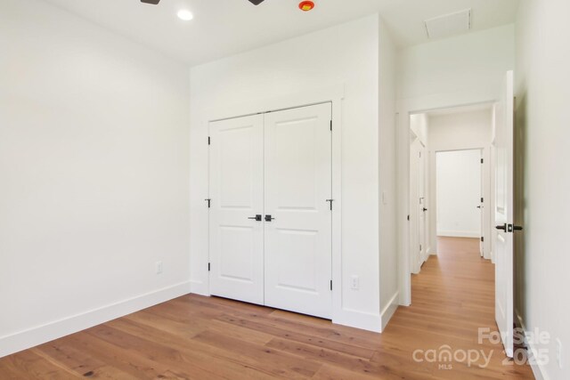 40 Haywood Park Dr, Hendersonville, NC 28791 - unfurnished bedroom featuring light wood-type flooring, baseboards, a closet, and recessed lighting