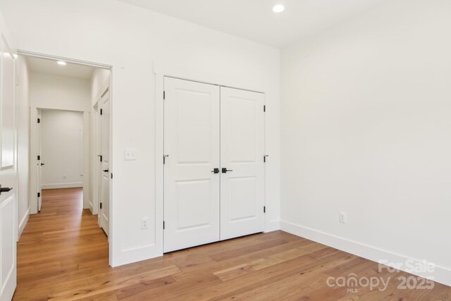 40 Haywood Park Dr, Hendersonville, NC 28791 - unfurnished bedroom with light wood-style floors, recessed lighting, a closet, and baseboards