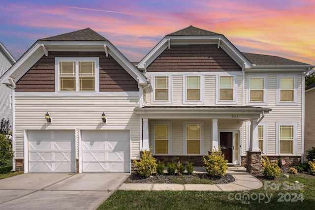 craftsman house with a garage and a porch