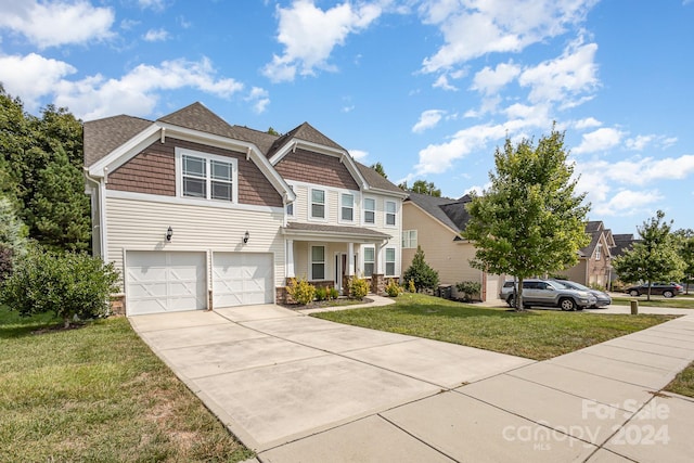 view of front of home with a garage and a front lawn