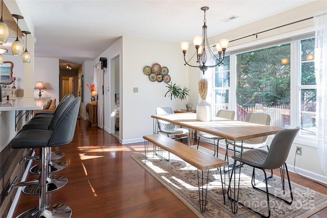 dining room with a chandelier and dark hardwood / wood-style floors