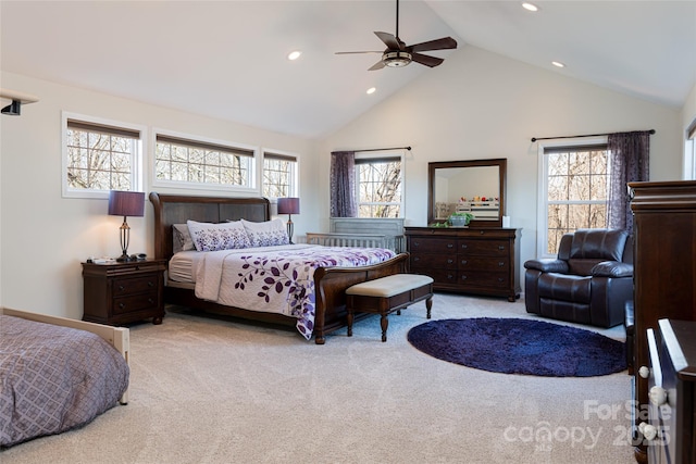 carpeted bedroom featuring ceiling fan and high vaulted ceiling