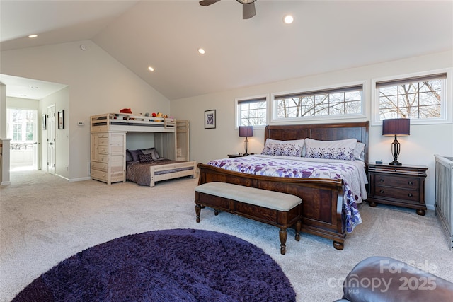 bedroom featuring ceiling fan, ensuite bathroom, lofted ceiling, and light carpet