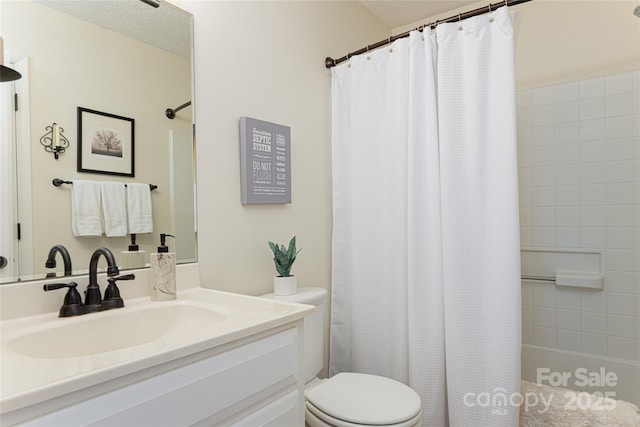 full bathroom with a textured ceiling, vanity, toilet, and shower / tub combo with curtain