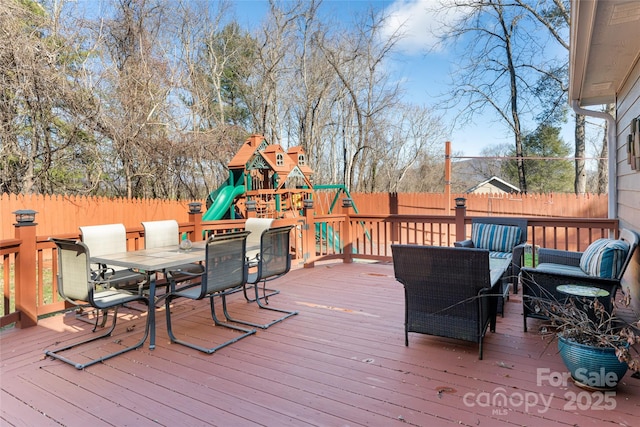 wooden terrace featuring a playground