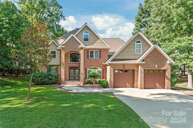 view of front facade with a garage and a front lawn