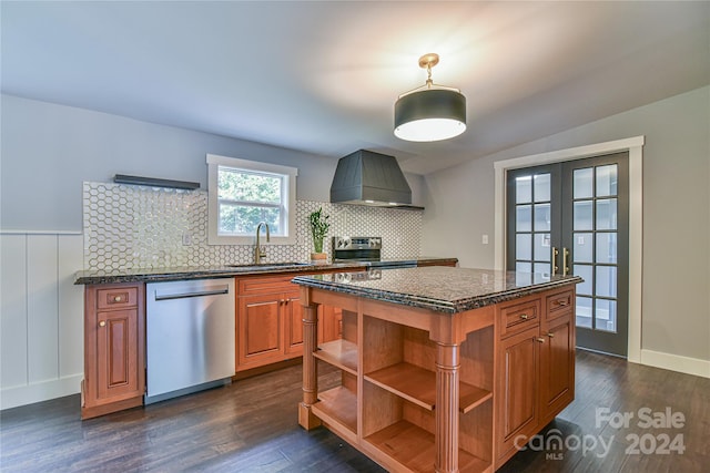 kitchen featuring stainless steel appliances, sink, wall chimney range hood, and dark hardwood / wood-style flooring