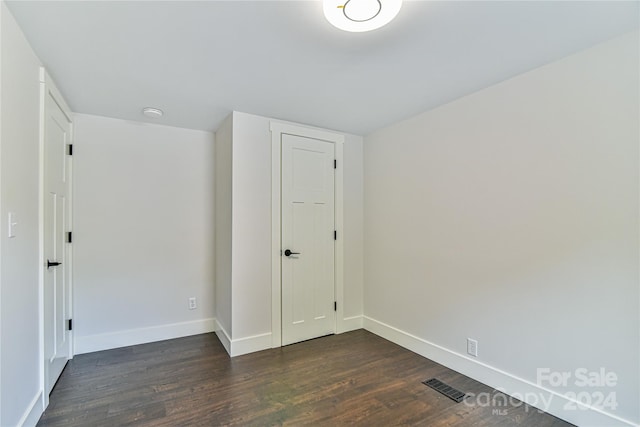 spare room featuring dark hardwood / wood-style floors