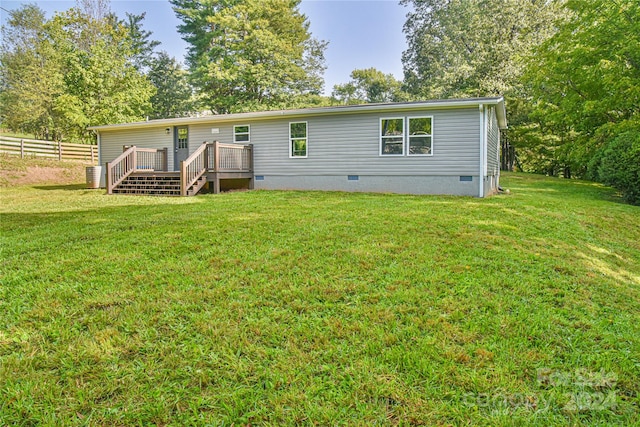 back of house with a yard, central AC, and a wooden deck