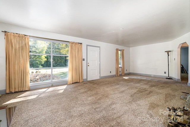 unfurnished living room featuring carpet