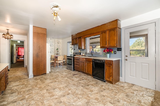 kitchen featuring black dishwasher, sink, stainless steel electric range, and a healthy amount of sunlight