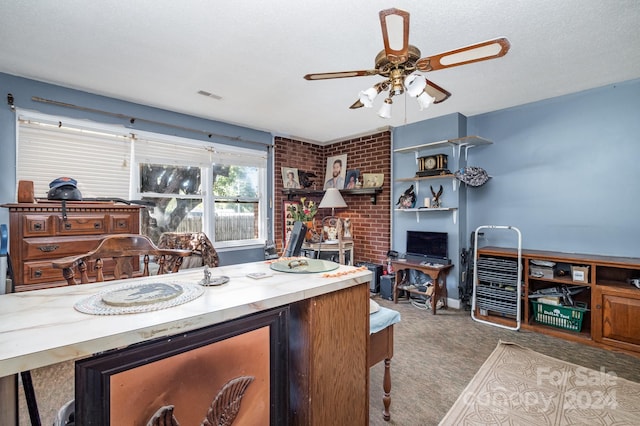 carpeted office space featuring ceiling fan and a textured ceiling