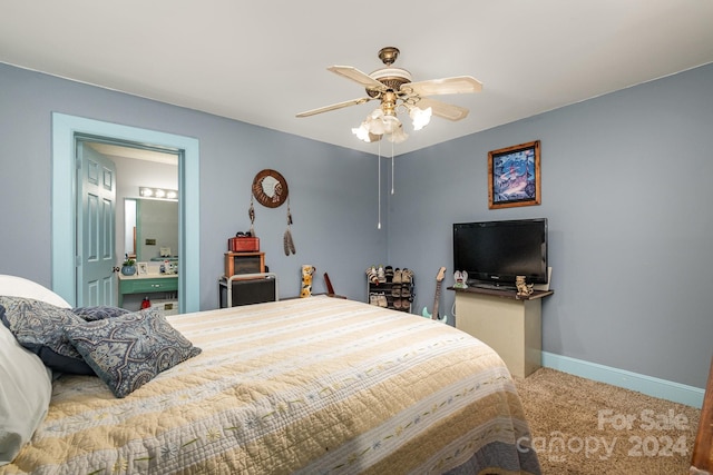 bedroom featuring ensuite bathroom, carpet flooring, and ceiling fan