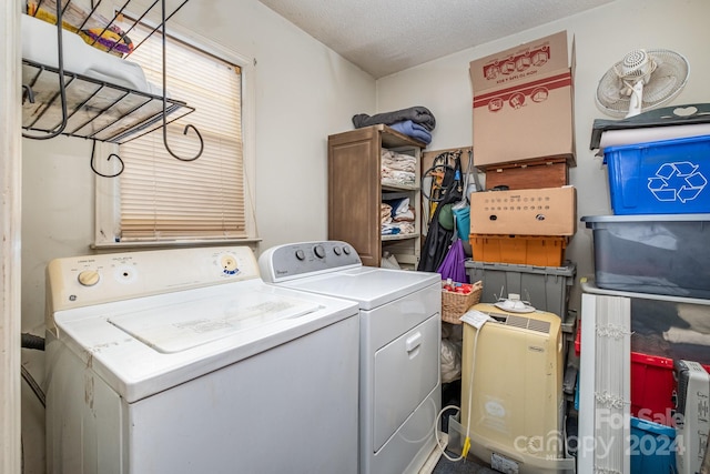 washroom with a textured ceiling and washing machine and clothes dryer