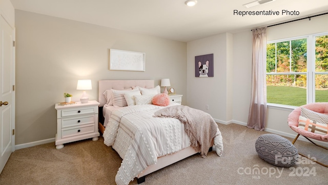 bedroom featuring light carpet