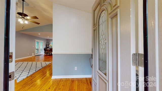 foyer entrance featuring ceiling fan, lofted ceiling, and light hardwood / wood-style flooring