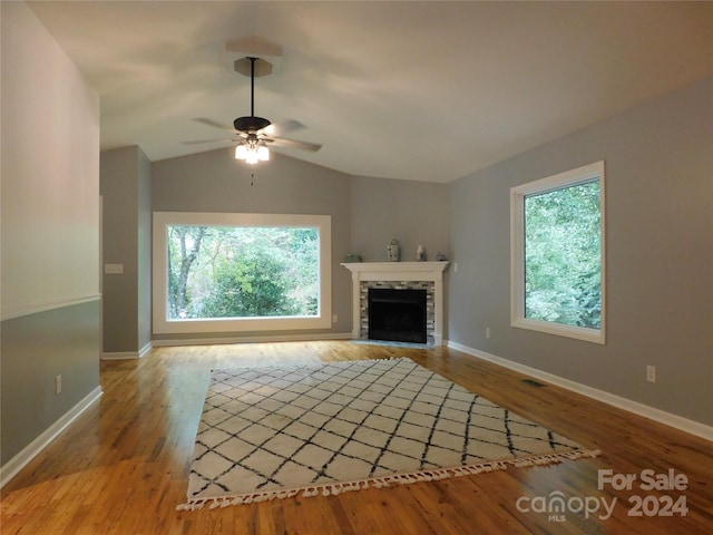 unfurnished living room featuring light wood-type flooring, vaulted ceiling, and ceiling fan